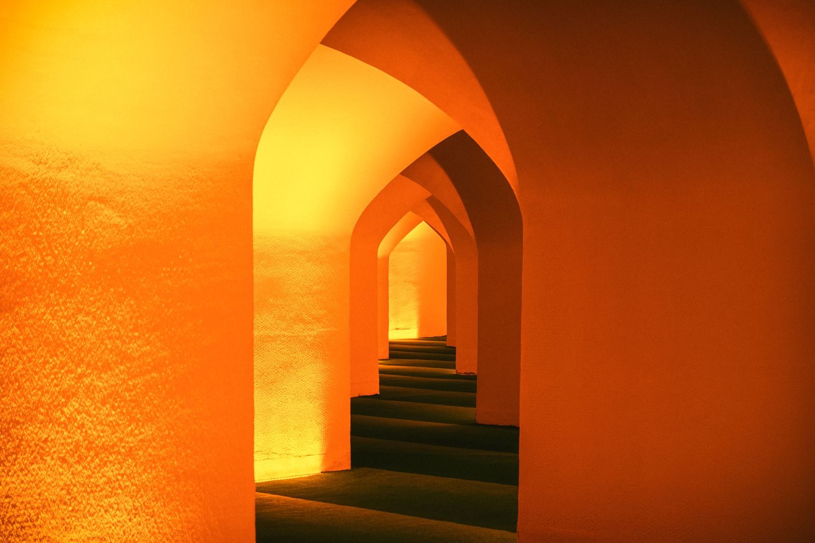 Warmly lit arched corridor photograph