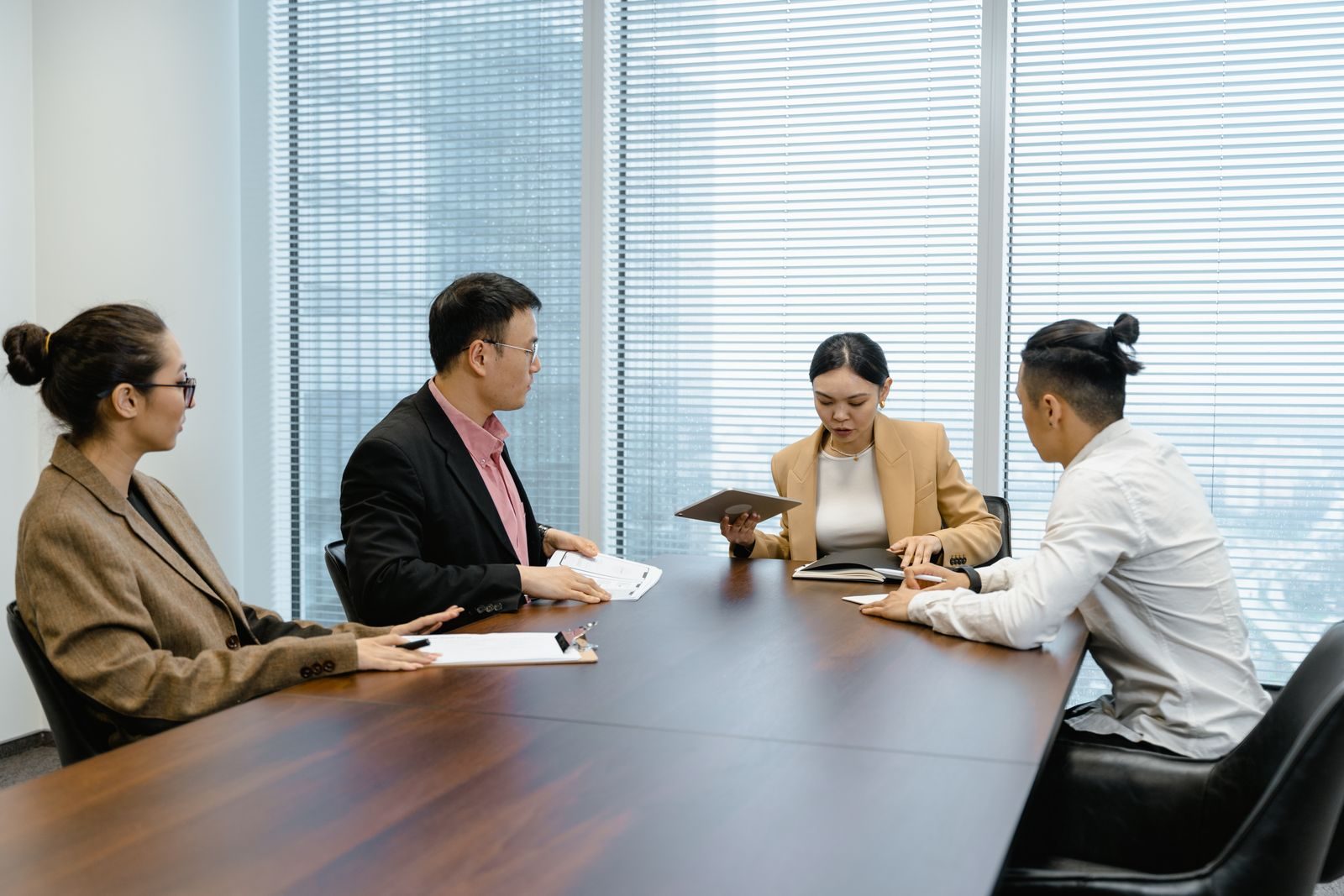 Team in discussion around a conference table photograph